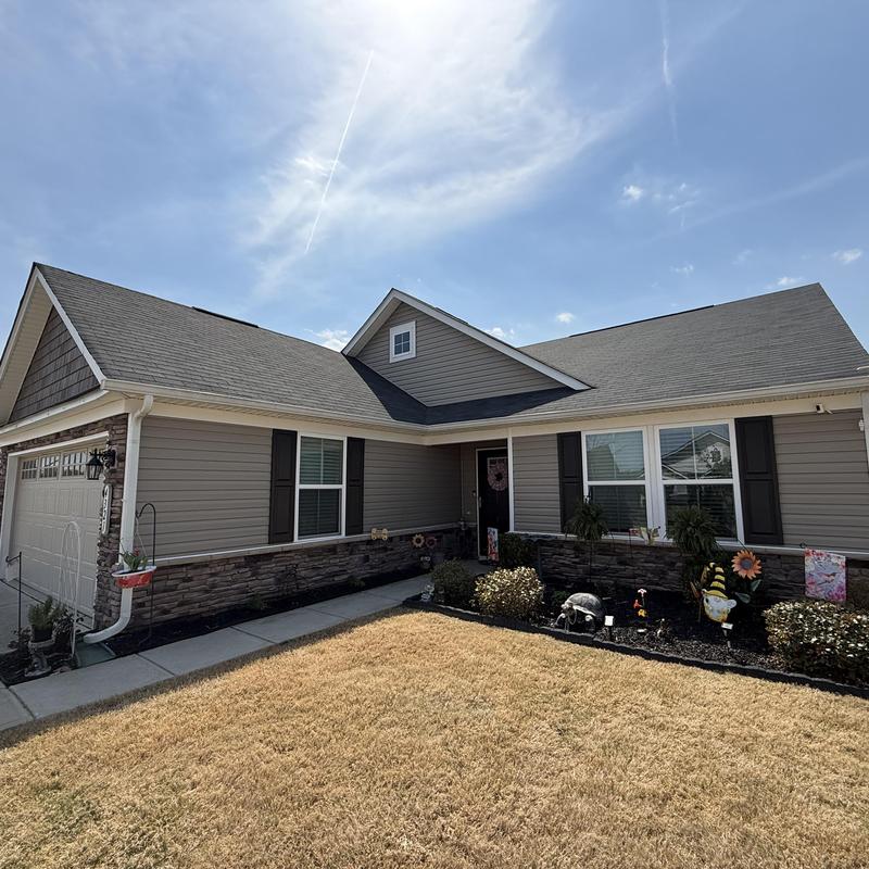 Residential roof with repaired shingles and pipe boots