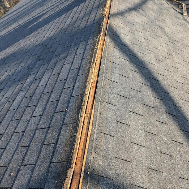 Roof ridge vent removed from asphalt shingle roof