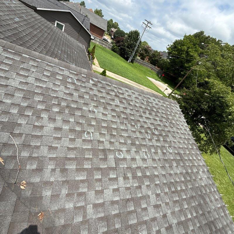 Asphalt shingles with marked hail damage on roof