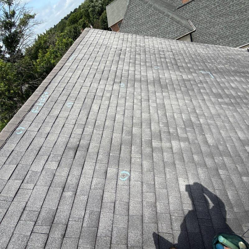 Roof shingles with hail damage markings and wear