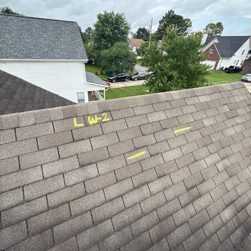Asphalt shingles with hail damage and chalk markings