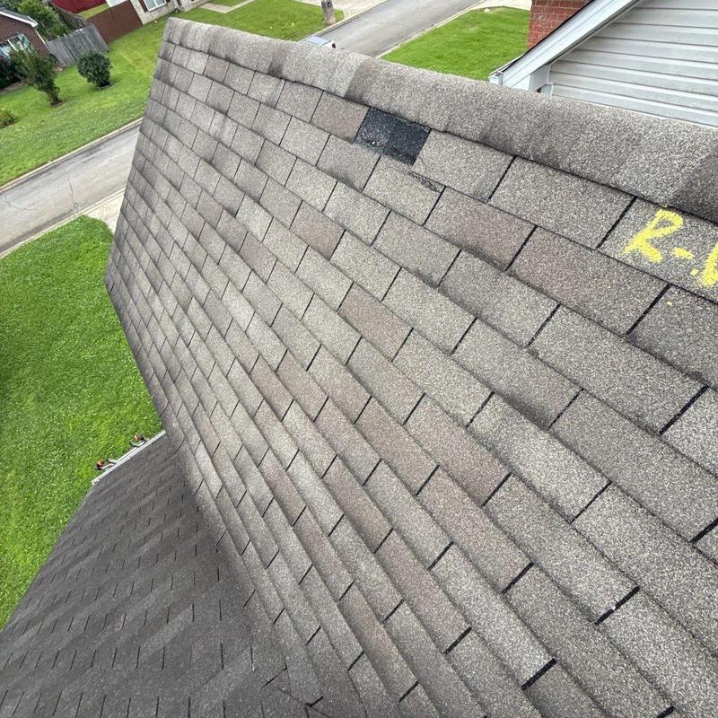 Architectural shingles with hail damage and granule loss