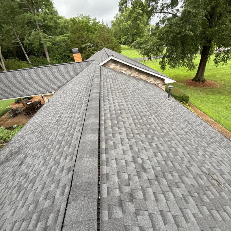 Asphalt shingle roof with ridge vent and flashing