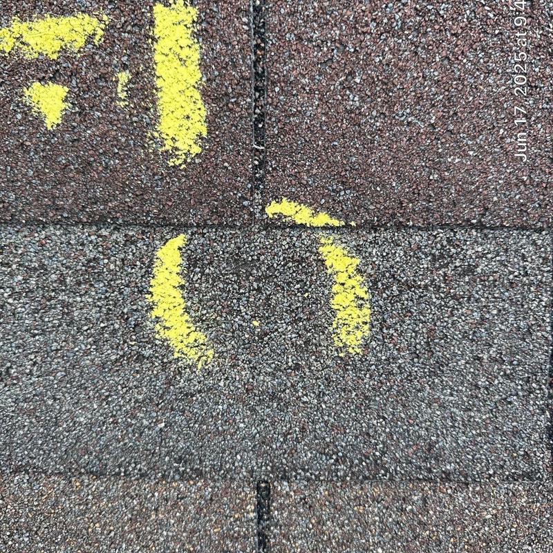 Roof shingles with marked hail damage and wear