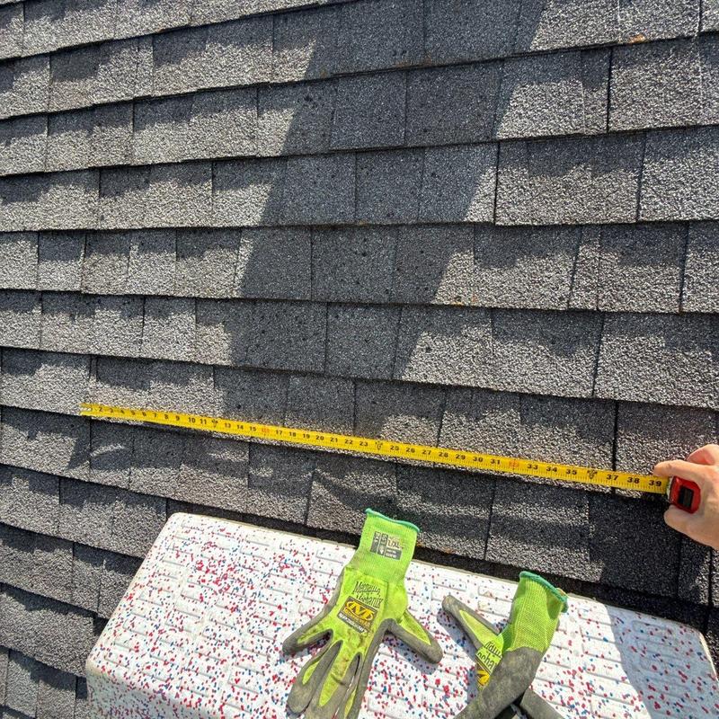 Roof shingles with measuring tape and work gloves