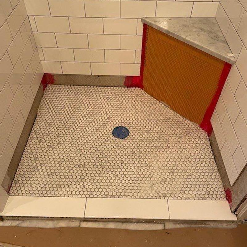 Shower pan with penny tile and wall waterproofing mesh