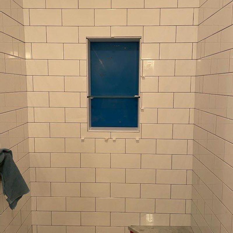 Shower tile walls with niche and window enclosure