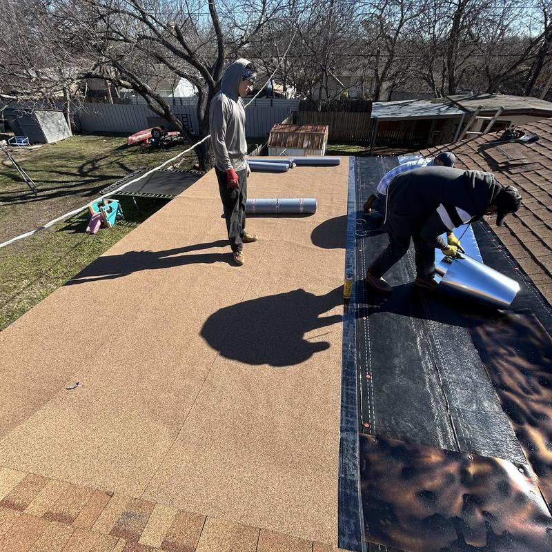Flat roof installation with protective underlayment in progress