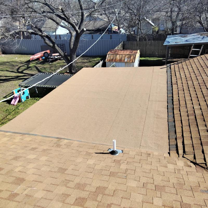 Flat roof replacement adjacent to shingle roof