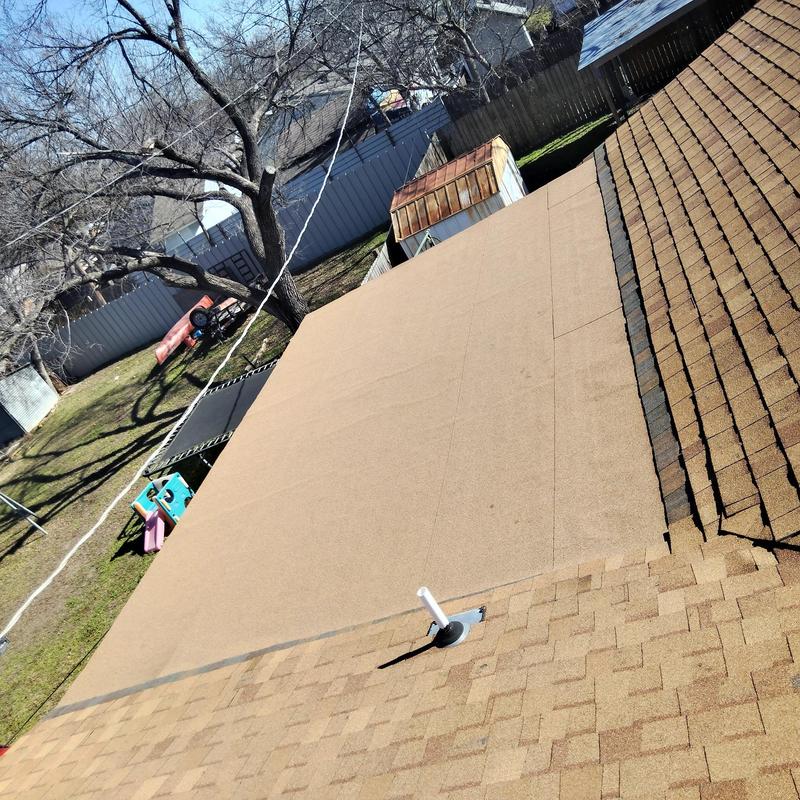Flat roof replacement with new covering next to shingles