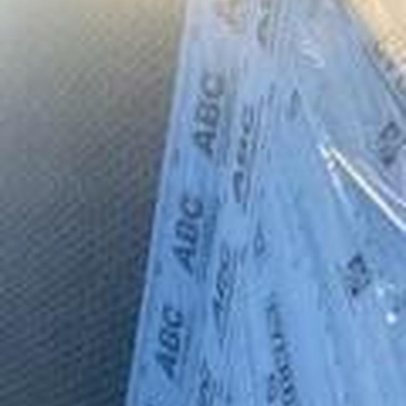 Synthetic roofing underlayment laid on roof decking