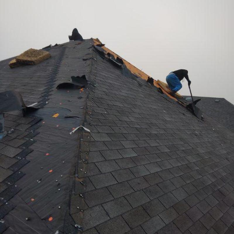 Roof shingles removal and decking inspection with workers