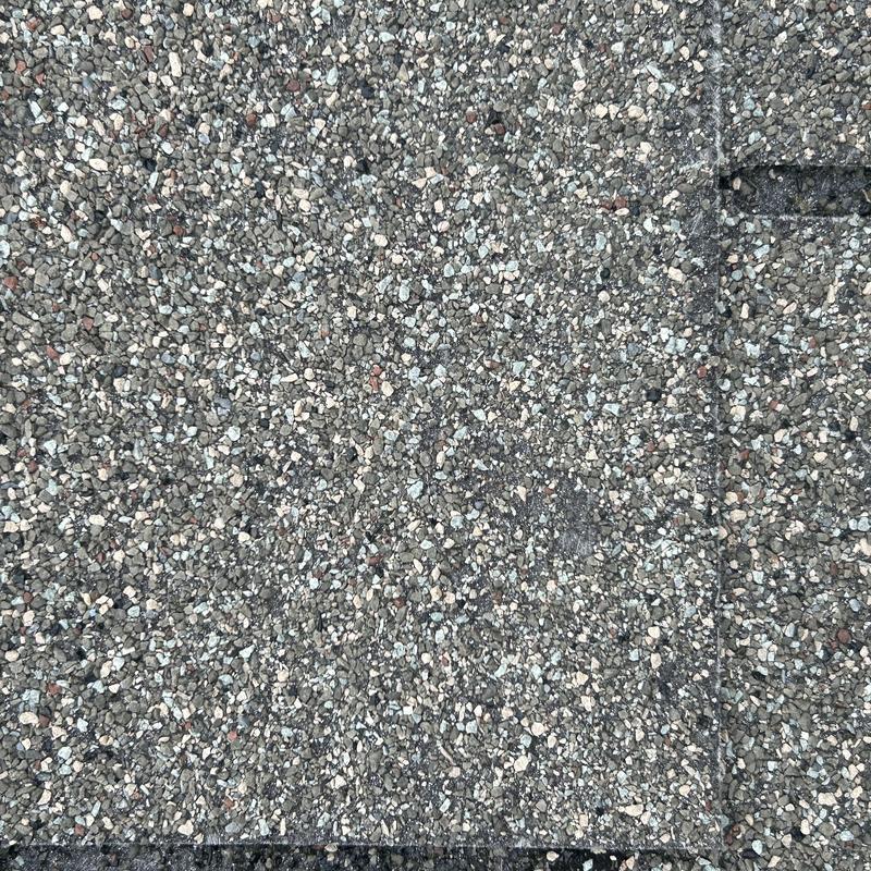 Asphalt shingle roof surface showing granule texture