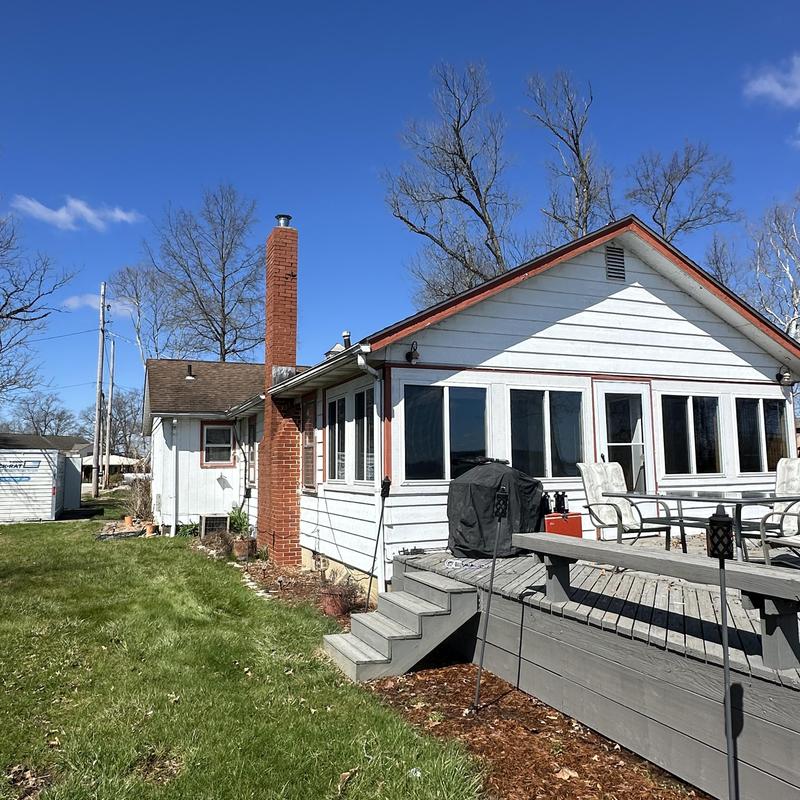 Siding and gutters on white home with deck Siding and gutters on white home with deck