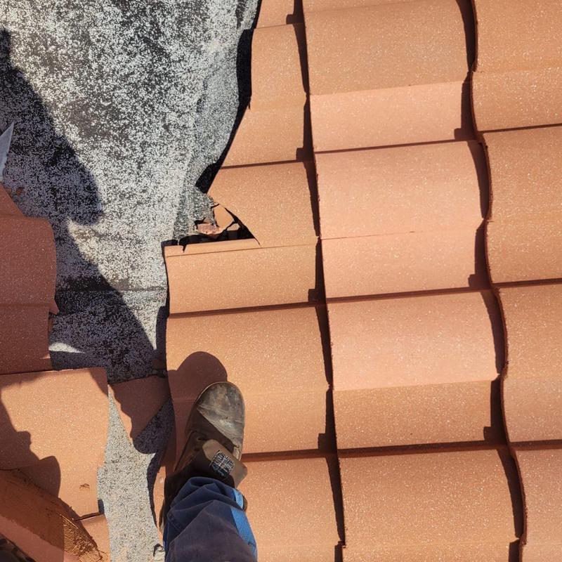 Tile roof damaged tiles and underlayment exposed