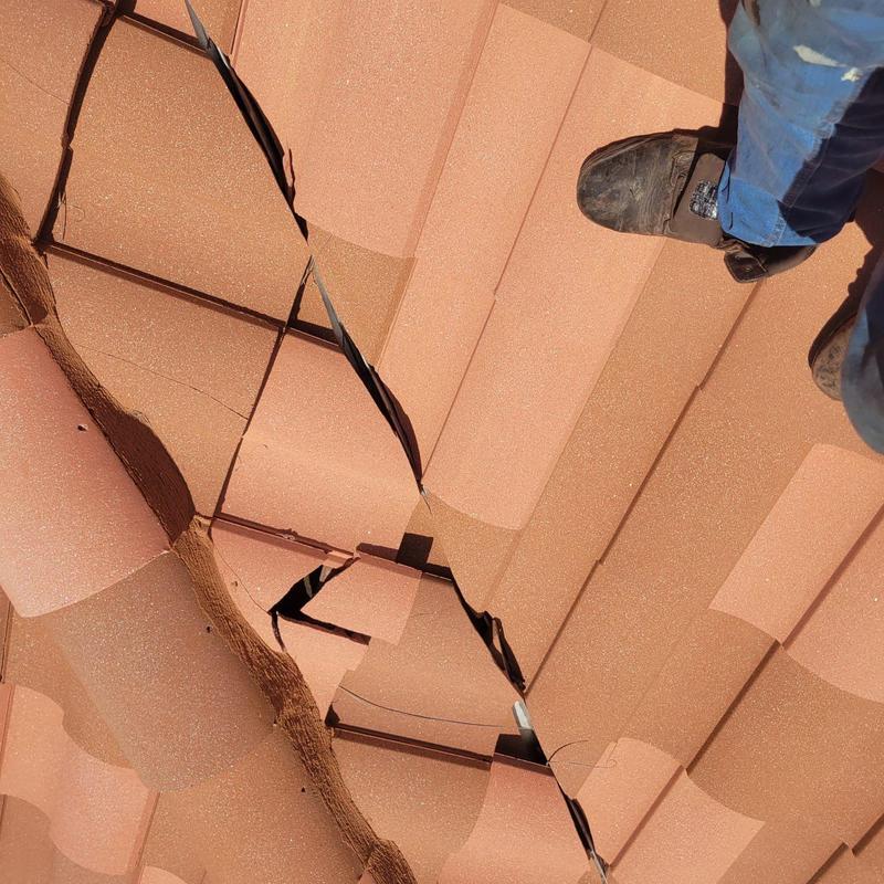 Tile roof with cracked and displaced tiles