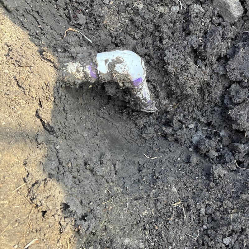 Water service line elbow joint with soil excavation
