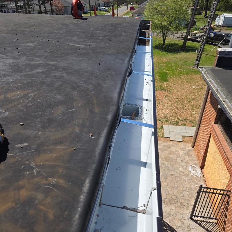 Commercial gutter and downspout system on flat roof Commercial gutter and downspout system on flat roof