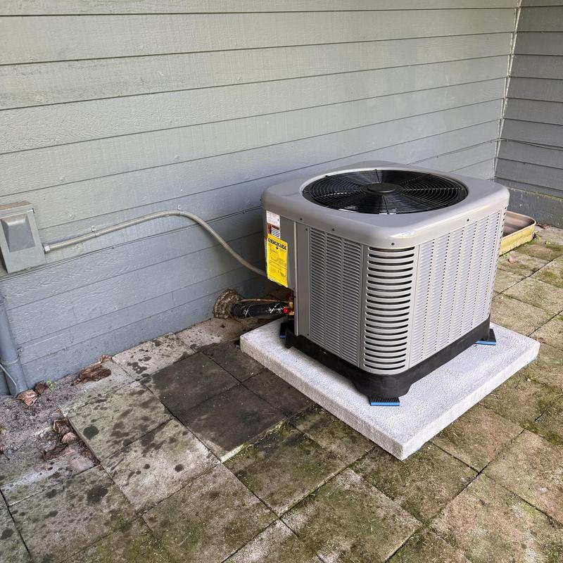 RUUD 13.4 SEER2 air conditioner installed outdoors RUUD 13.4 SEER2 air conditioner installed outdoors