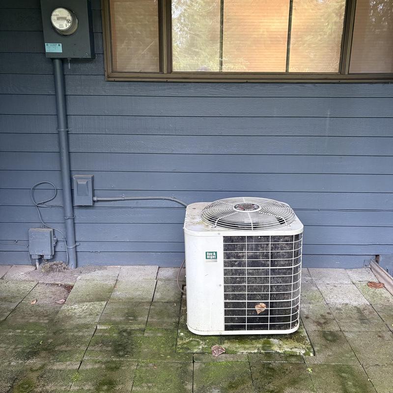 Day & Night air conditioner unit on patio outdoors Day & Night air conditioner unit on patio outdoors