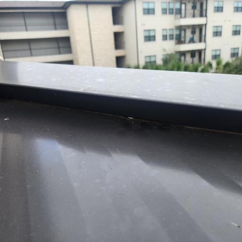 Standing seam metal roof gap at headwall flashing