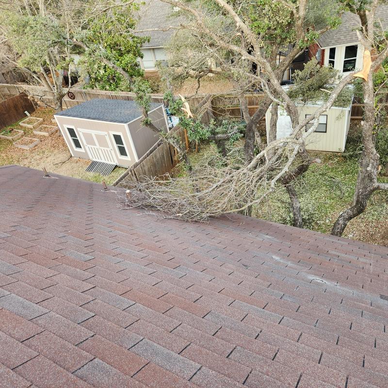 GAF Hickory shingles with wind damage and debris GAF Hickory shingles with wind damage and debris