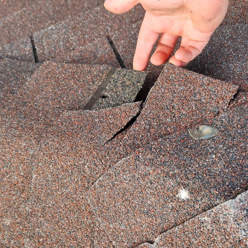 GAF Hickory shingles with wind damage and punctures GAF Hickory shingles with wind damage and punctures
