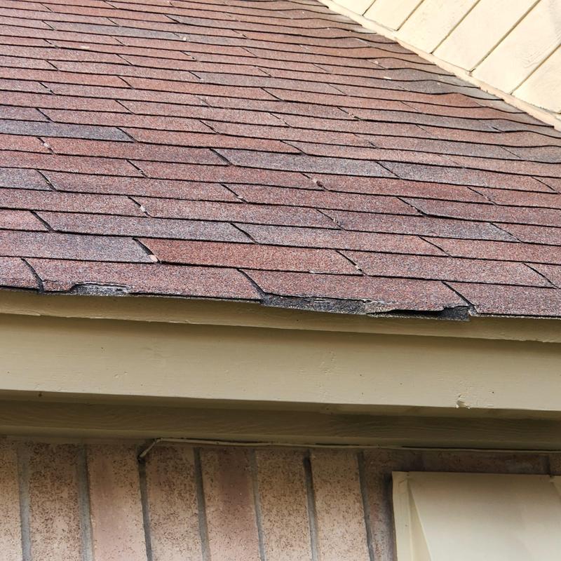 GAF Hickory shingles with wind damage and missing pieces GAF Hickory shingles with wind damage and missing pieces