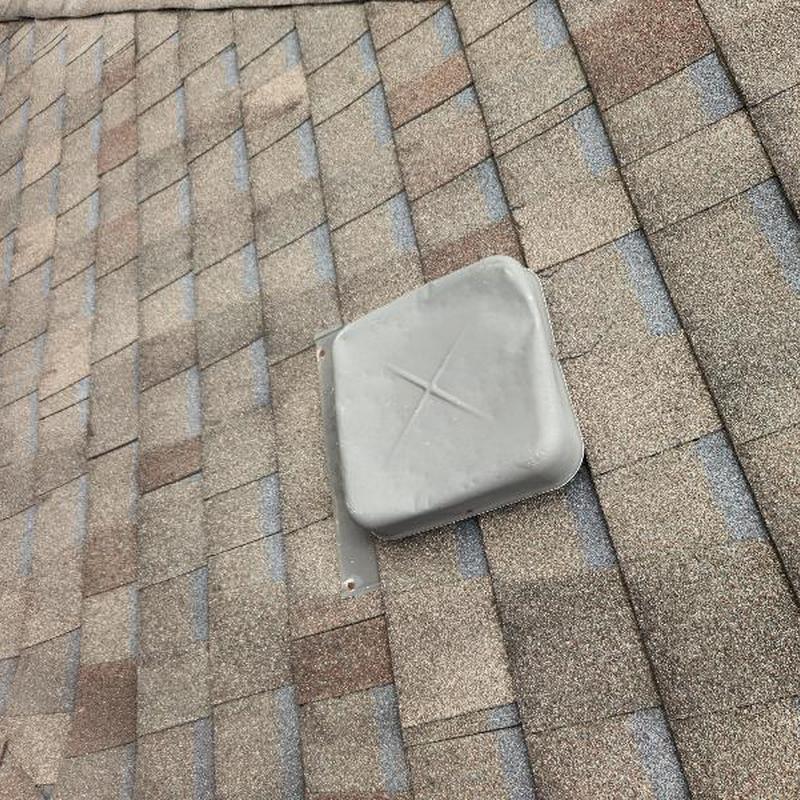 Roof shingles and vent cover with minor damage Roof shingles and vent cover with minor damage
