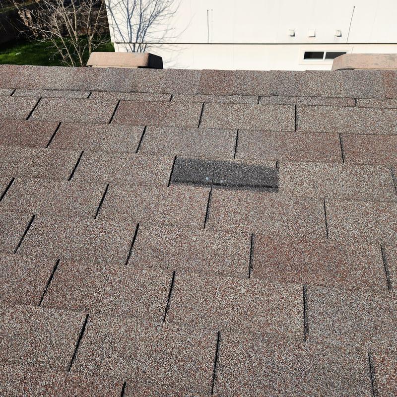Asphalt roof shingles with damaged and missing tabs Asphalt roof shingles with damaged and missing tabs