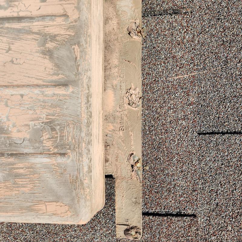 Roof shingles and damaged roof edge with staples visible Roof shingles and damaged roof edge with staples visible
