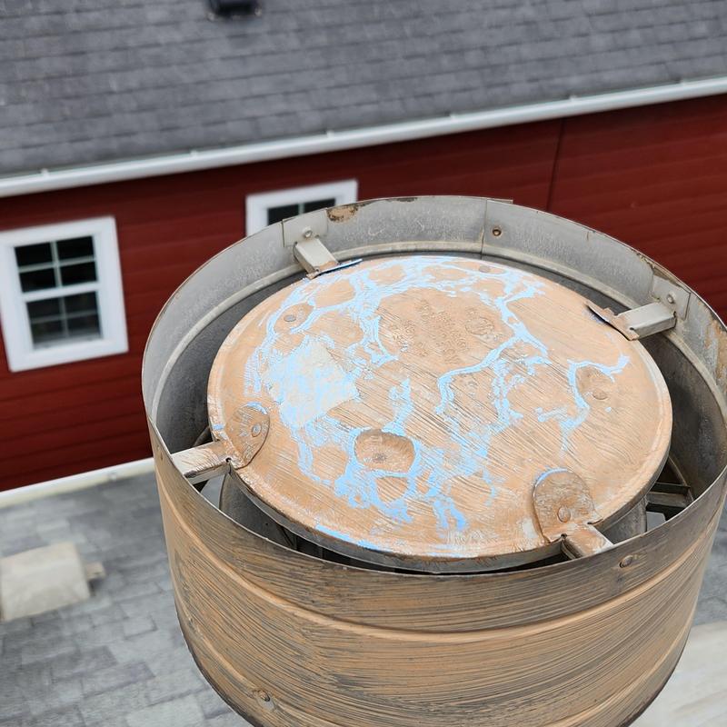 Roof ventilation cap with weathered paint on shingle roof Roof ventilation cap with weathered paint on shingle roof