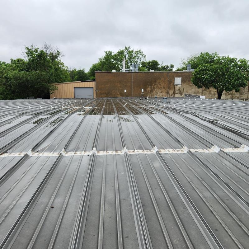 Metal storage unit roof with recent leak repairs