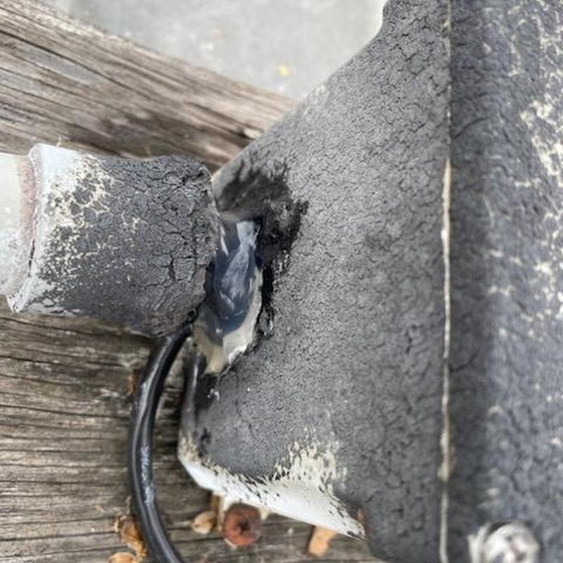 Rubber roofing patch with sealant on metal panel junction