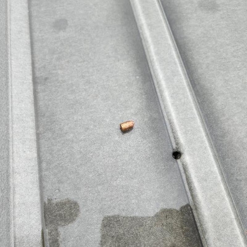 Metal roofing panel with hole and water stain