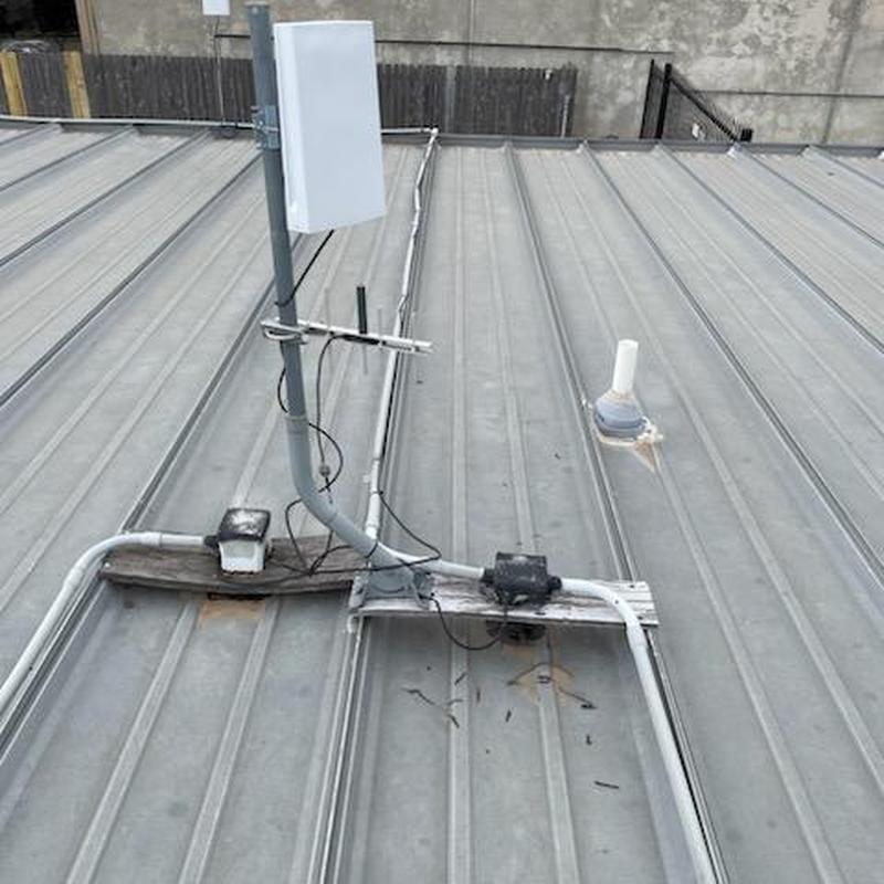 Metal roof panels with electrical conduit on rooftop