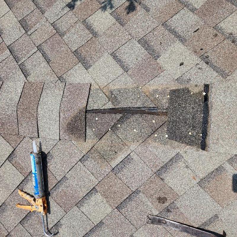 Asphalt roofing shingles with sealant gun and pry bar