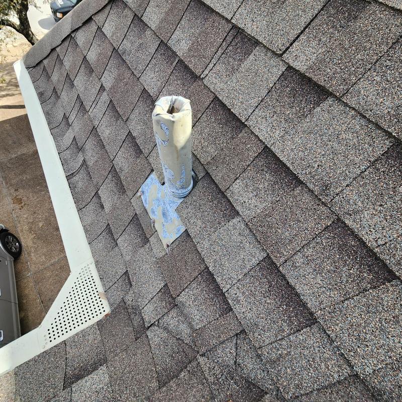 Plumbing boot with caulk on asphalt shingle roof Plumbing boot with caulk on asphalt shingle roof