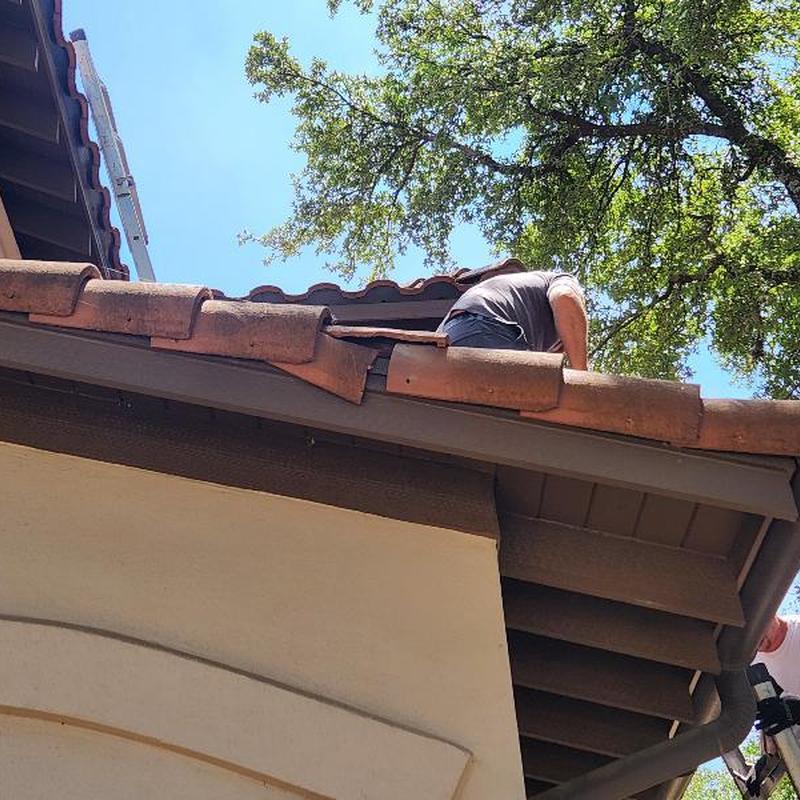 Clay roof tiles with lead flashing and worker on roof Clay roof tiles with lead flashing and worker on roof