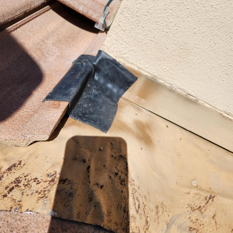 Roof tile corner with flashing and vent attachment detail Roof tile corner with flashing and vent attachment detail