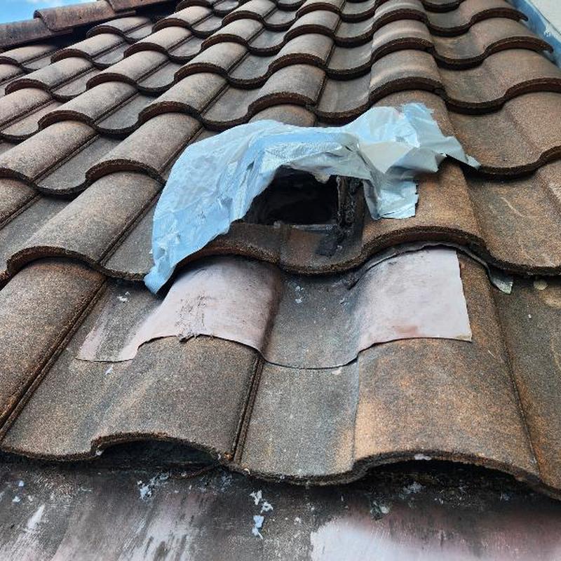 Tile roof vent with temporary plastic covering and damage Tile roof vent with temporary plastic covering and damage