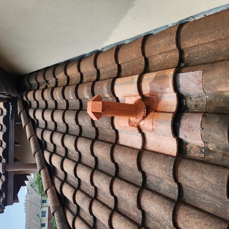 Dryer vent pipe with new tile flashing on roof Dryer vent pipe with new tile flashing on roof
