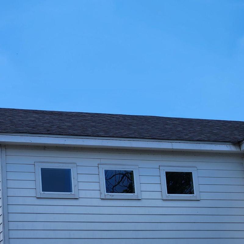 Charcoal black roof shingles with three small windows Charcoal black roof shingles with three small windows