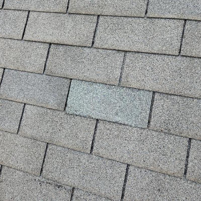 3-tab shingles with one replacement shingle visible 3-tab shingles with one replacement shingle visible