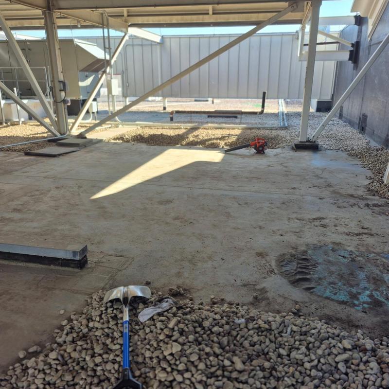 Ballasted EPDM roof membrane with tools on gravel Ballasted EPDM roof membrane with tools on gravel