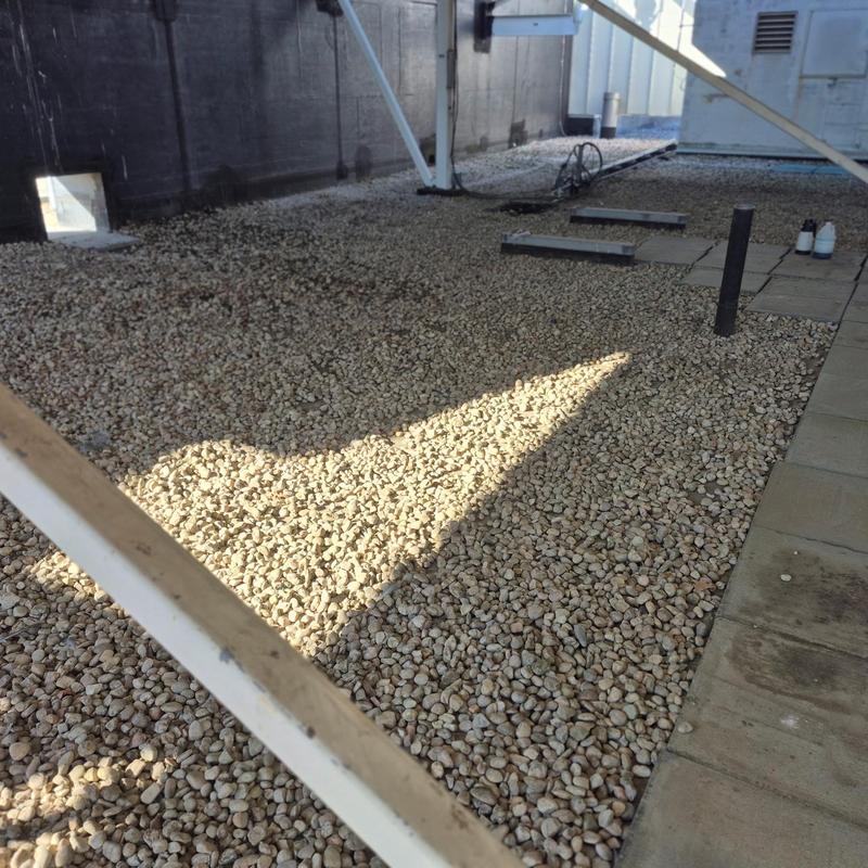 Ballasted EPDM roof with gravel ballast and drainage vents Ballasted EPDM roof with gravel ballast and drainage vents