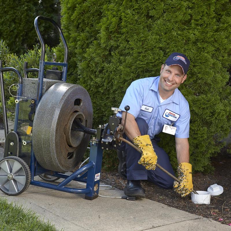 Drain cleaning machine clearing office bathroom clog outdoors