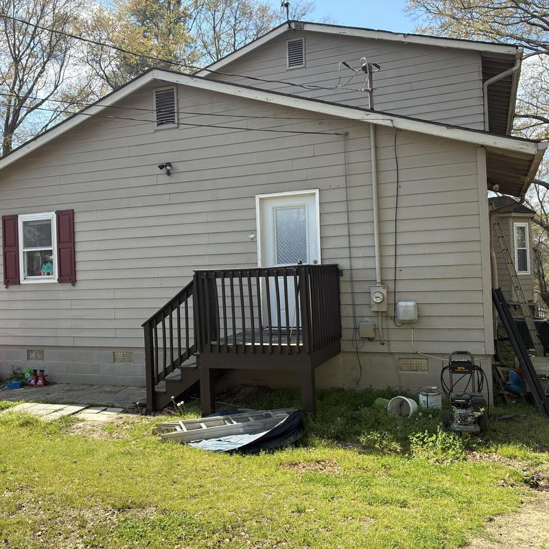 Pressure treated wood landing with steps side house