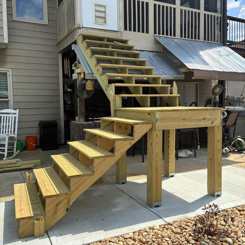 Wooden exterior staircase with landing platform