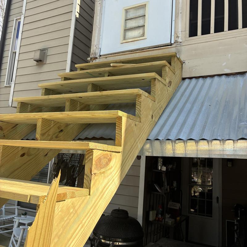 Wooden staircase framing on raised deck entrance